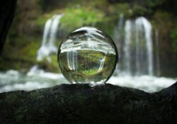 glass orb with waterfall behind